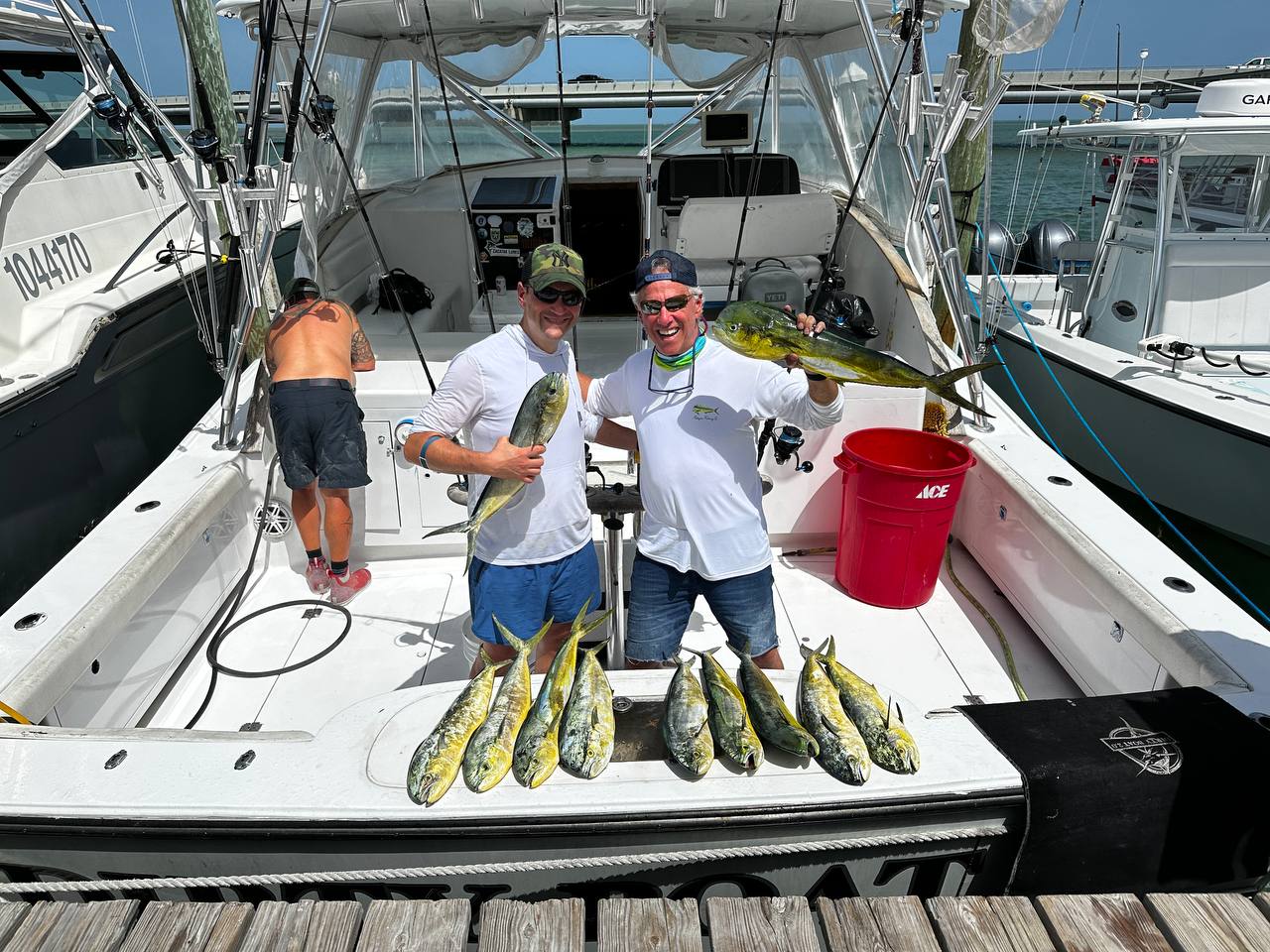 Harvey and Jason with a dozen schoolie mahi spread across the cockpit of the Dirty Boat