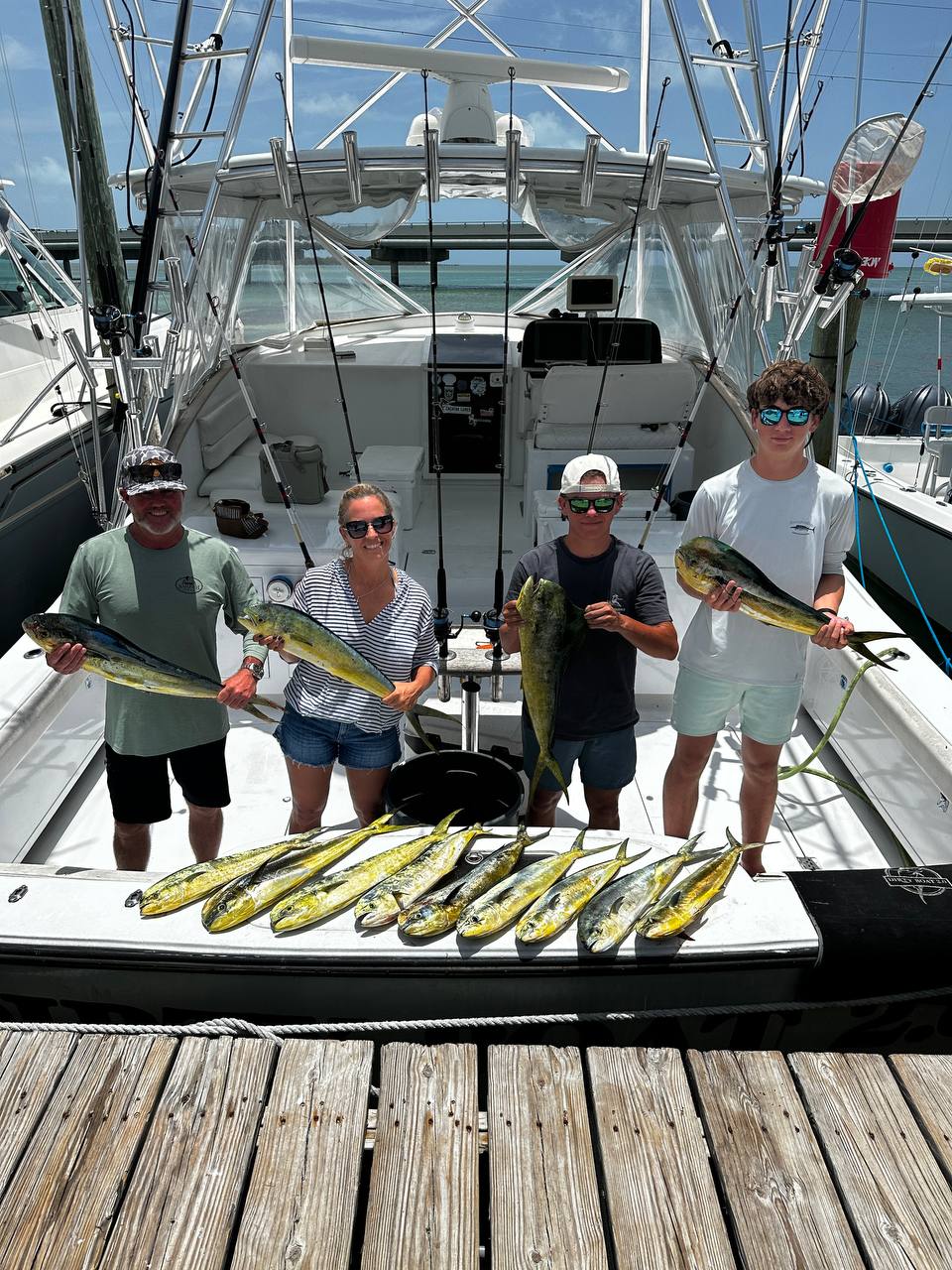 Chris and the family from West Virginia with their mahi spread out on the dock