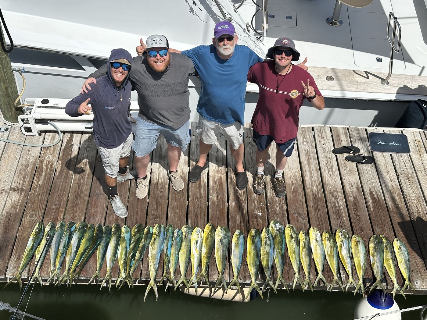 Angel, Bill, Matt and Thomas with the full run of mahi on the dock