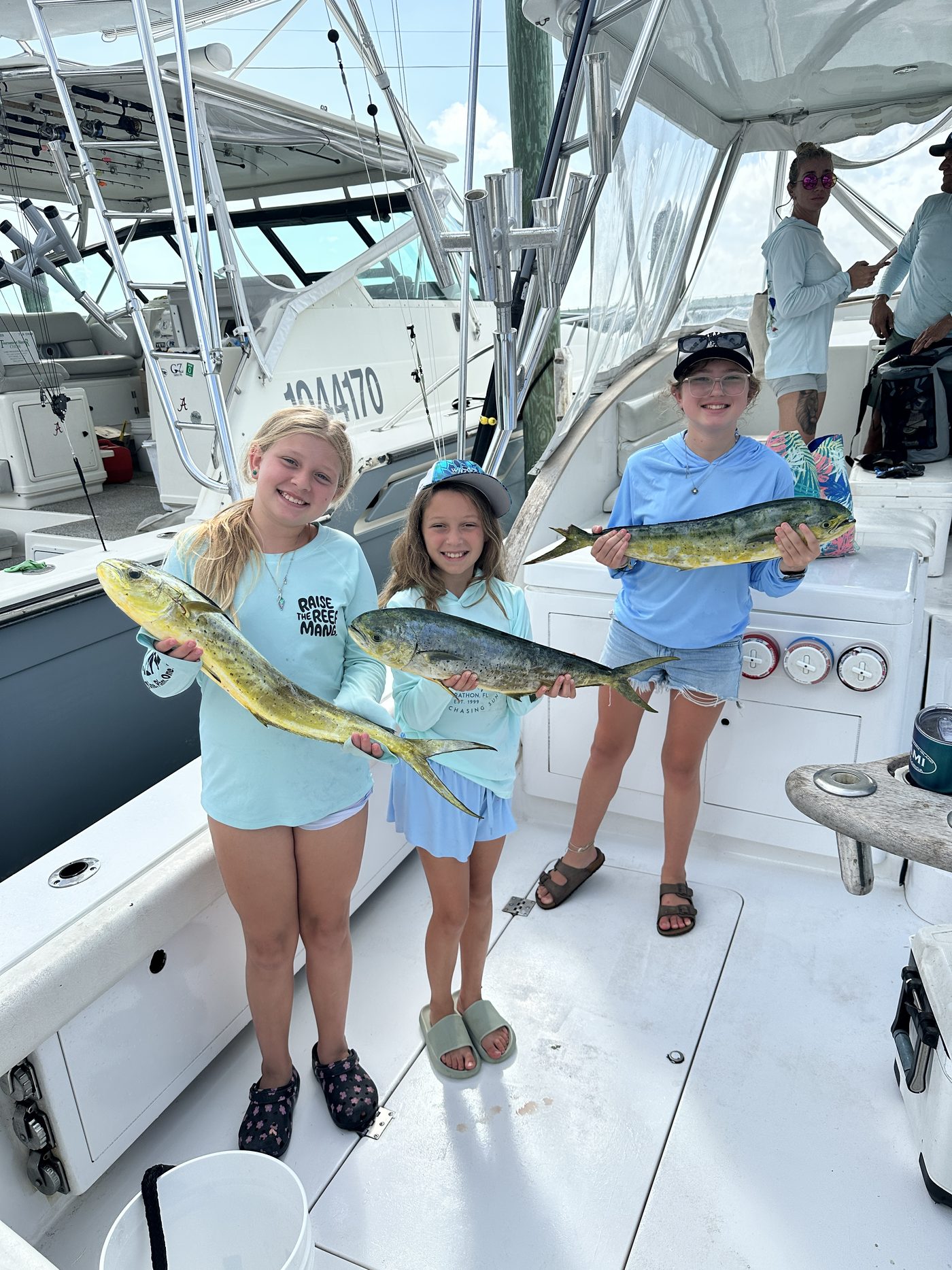 MaryPat, Emily and Antonia on deck with mahi from the morning bite