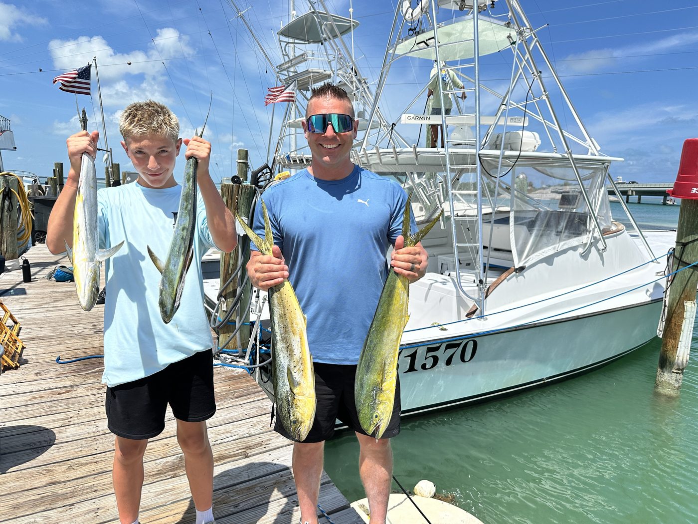 Isaac and his dad Matt with the day's mahi